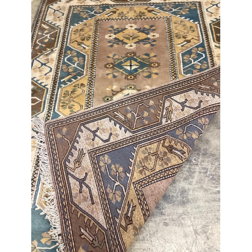 1024 - A modern Caucasian style fawn ground rug, 230 x 168cm