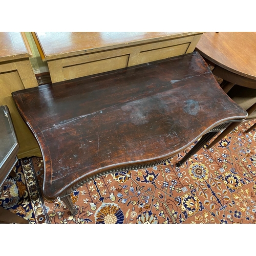 1033 - A George III mahogany serpentine folding card table, width 93cm, depth 48cm, height 72cm