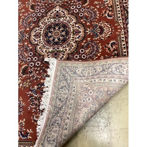 1054 - A modern Tabriz style red ground rug, 240 x 162cm