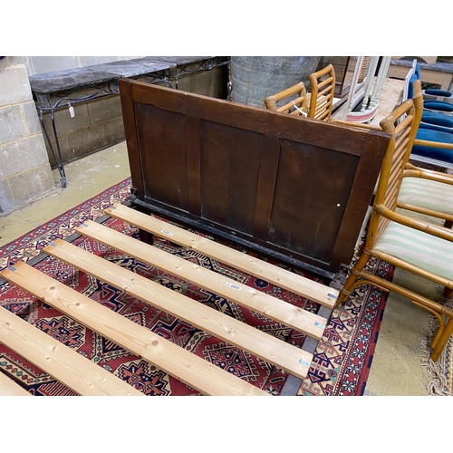 1058 - An 18th century style panelled oak bedframe, length 198cm, width 122cm, height 130cm