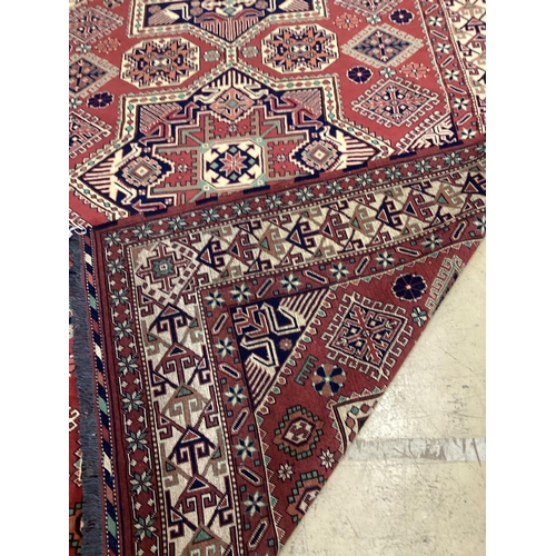 1059 - A modern Caucasian style red ground carpet 300cm x 210cm