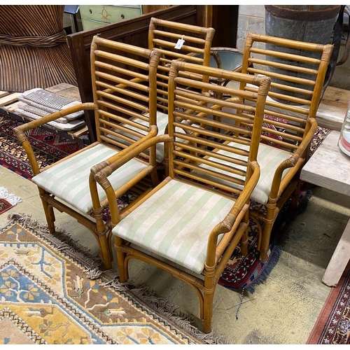 1061 - A set of four bamboo elbow chairs with upholstered seats, width 59cm, depth 48cm, height 99cm