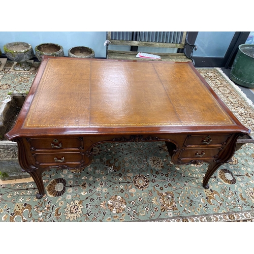 51 - An early 20th century mahogany kneehole partner's desk with tooled tan leather inset top, length 154... 