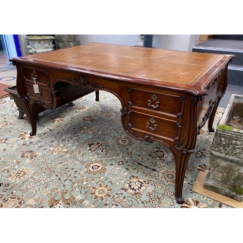 51 - An early 20th century mahogany kneehole partner's desk with tooled tan leather inset top, length 154... 