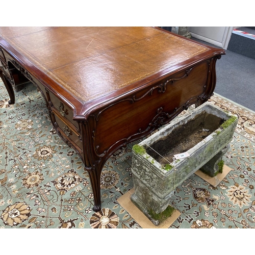 51 - An early 20th century mahogany kneehole partner's desk with tooled tan leather inset top, length 154... 