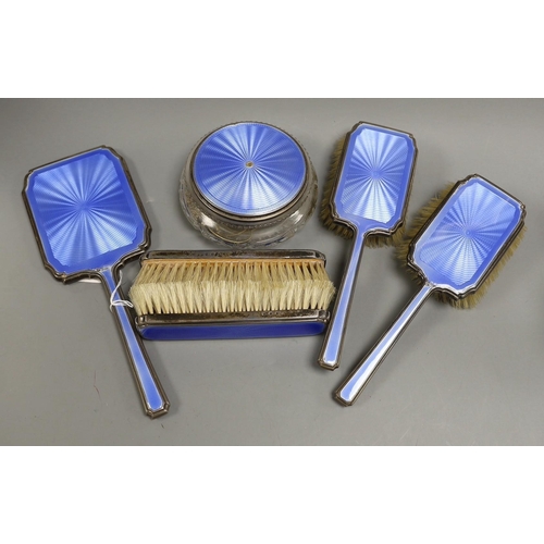 1826 - A 1930's silver and blue guilloche enamel six piece dressing table set, including hand mirror and to... 