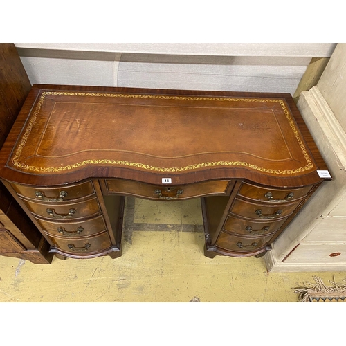 15 - A reproduction mahogany leather topped kneehole writing table, width 114cm, depth 53cm, height 75cm... 