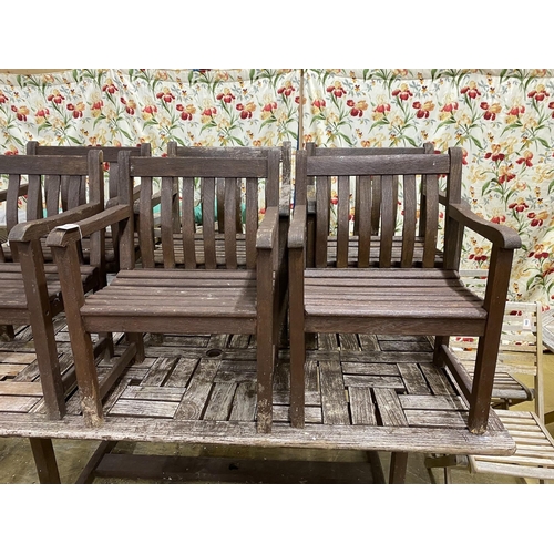 22 - A rectangular weathered teak garden table, length 212cm, width 110cm, height 74cm and six elbow chai... 