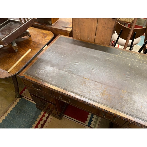 33 - An early 20th century Chippendale revival mahogany pedestal desk, requiring restoration, length 135c... 