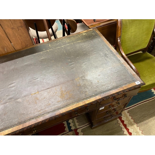 33 - An early 20th century Chippendale revival mahogany pedestal desk, requiring restoration, length 135c... 