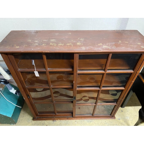 4 - An early 20th century pine sliding door cabinet, width 129cm, depth 38cm, height 125cm