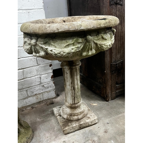 1010 - A reconstituted stone circular garden planter, width 49cm, height 65cm