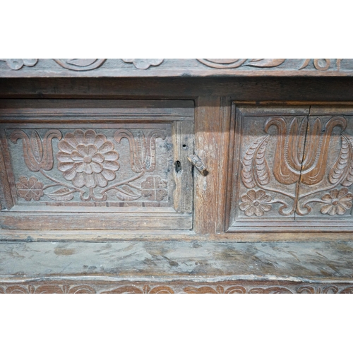 1011 - A 17th century carved oak court cupboard, dated 1685, width 170cm, depth 55cm, height 150cm