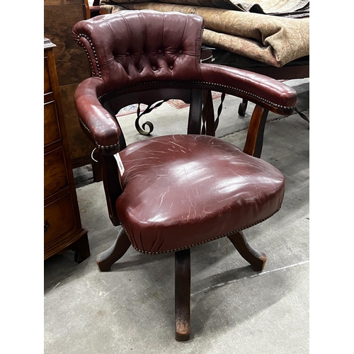 1026 - An early 20th century burgundy leather tub framed swivel desk chair, width 61cm, depth 50cm, height ... 