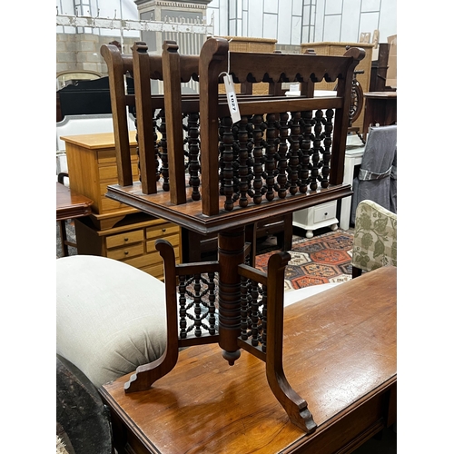 1027 - An early 20th century Moorish style walnut three division revolving newspaper stand, width 42cm, dep... 