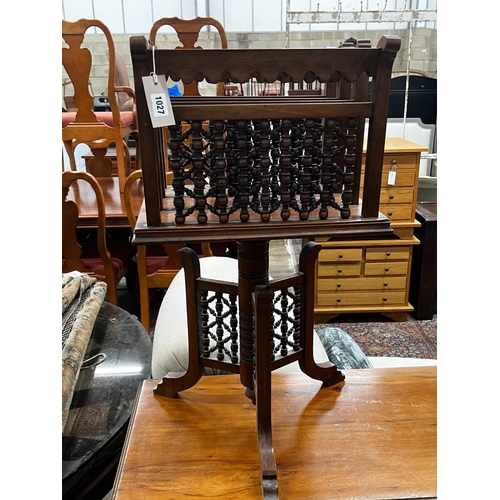 1027 - An early 20th century Moorish style walnut three division revolving newspaper stand, width 42cm, dep... 