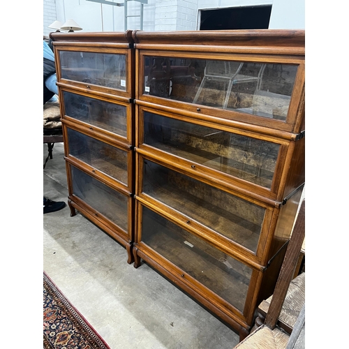 1050 - A pair of Globe Wernicke four section walnut bookcases, length 87cm, depth 31cm, height 147cm