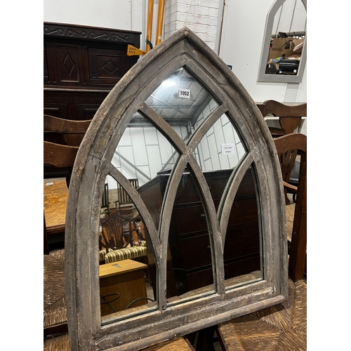 1052 - A gothic style painted arched wall mirror, width 66cm, height 81cm