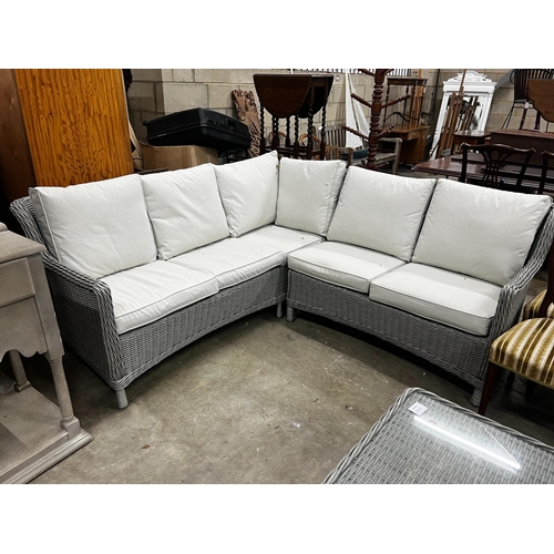 1056 - A contemporary Kettler all weather rattan corner garden sofa with matching table and four stools, ta... 