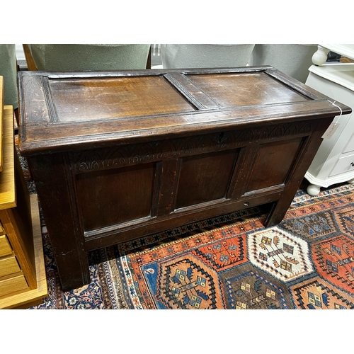 1064 - A late 17th / early 18th century panelled oak coffer, length 108cm, depth 48cm, height 66cm