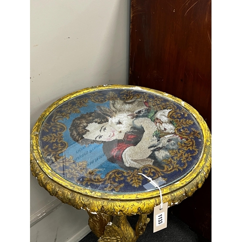 1133 - A Victorian giltwood and composition circular centre table with polychrome beadwork top on a carved ... 