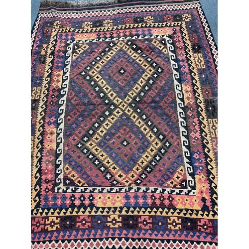 1149 - A polychrome flatweave rug, 203 x 160cm