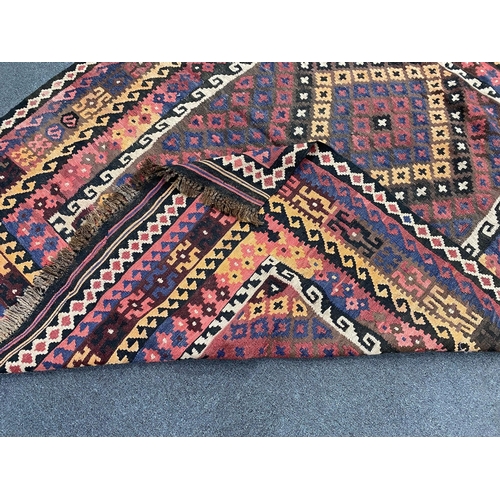 1149 - A polychrome flatweave rug, 203 x 160cm