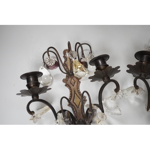 1279 - A pair of bronze or brass two branch wall sconces with cut glass drops,