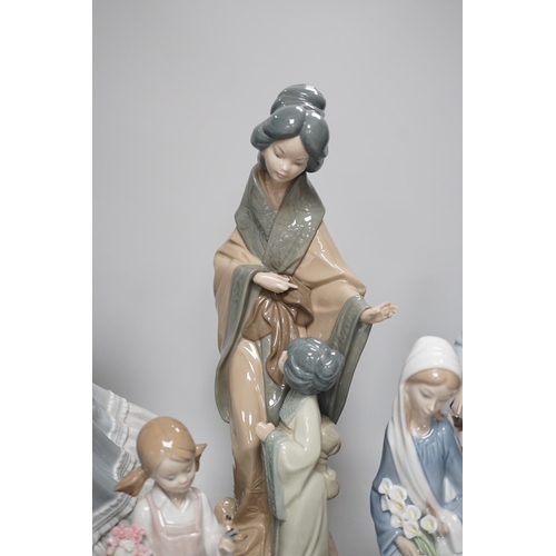 1302 - Seven Lladro and two Nao porcelain figures together with another, stuck to base so mark cant be see... 