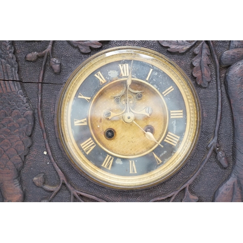 1307 - A late 19th century / early 20th century folk art carved oak cased clock, decorated with hanging dea... 