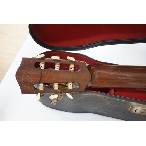 1309 - A Harald Petersen classical concert guitar, paper label interior, with hard case. Length of back 49c... 