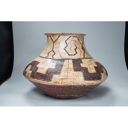 1319 - A Shipibo pottery water vessel with geometric pattern, Peru, 26cm tall