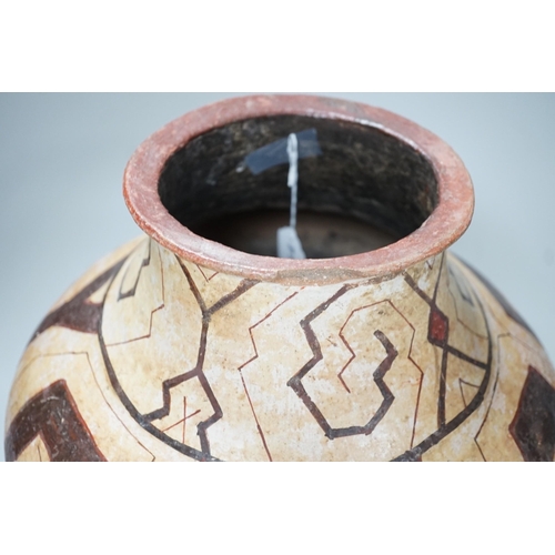 1319 - A Shipibo pottery water vessel with geometric pattern, Peru, 26cm tall