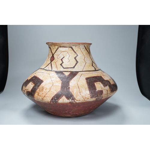 1319 - A Shipibo pottery water vessel with geometric pattern, Peru, 26cm tall