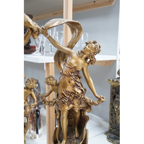 1340 - A pair of gilt spelter groups of a classical maiden and cherub, 61cm tall