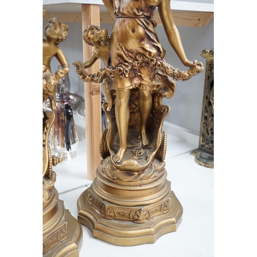 1340 - A pair of gilt spelter groups of a classical maiden and cherub, 61cm tall