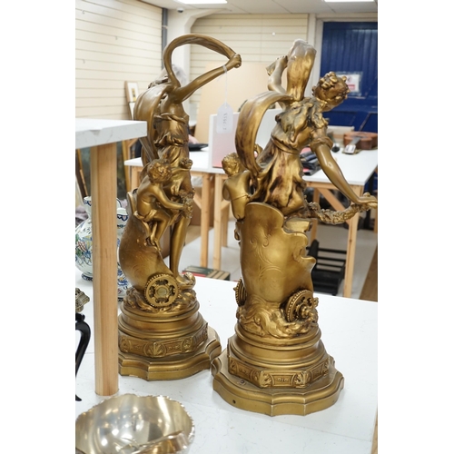 1340 - A pair of gilt spelter groups of a classical maiden and cherub, 61cm tall