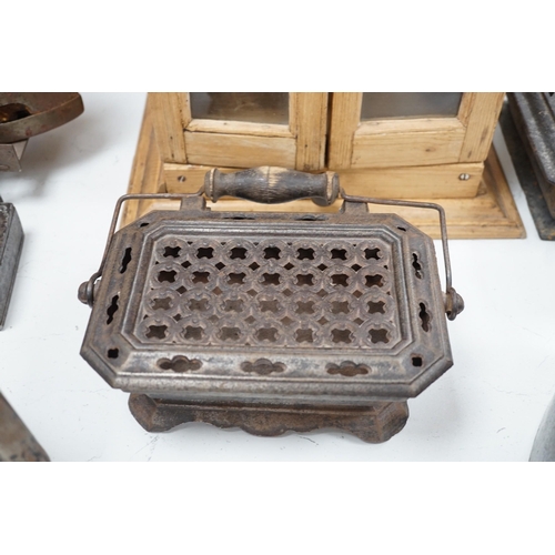 1343 - Four French coal/slug irons, three trivets and a stripped pine glazed cabinet, 37cm high