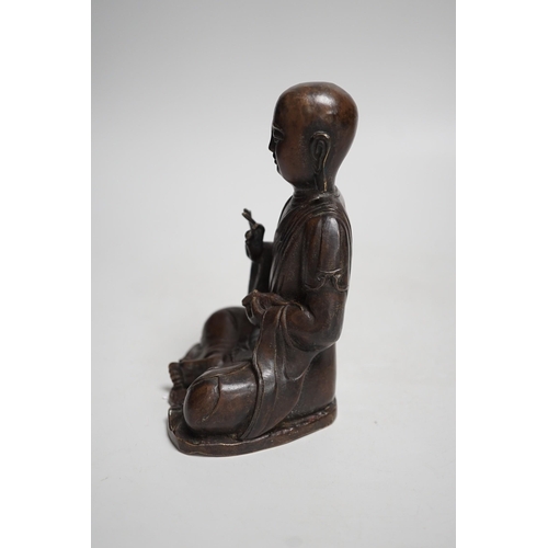 1390 - A Nepalese bronze figure of a seated immortal, probably 17th / 18th century, 16cm