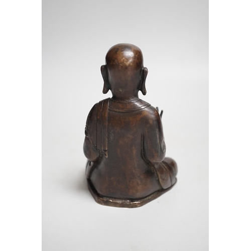 1390 - A Nepalese bronze figure of a seated immortal, probably 17th / 18th century, 16cm