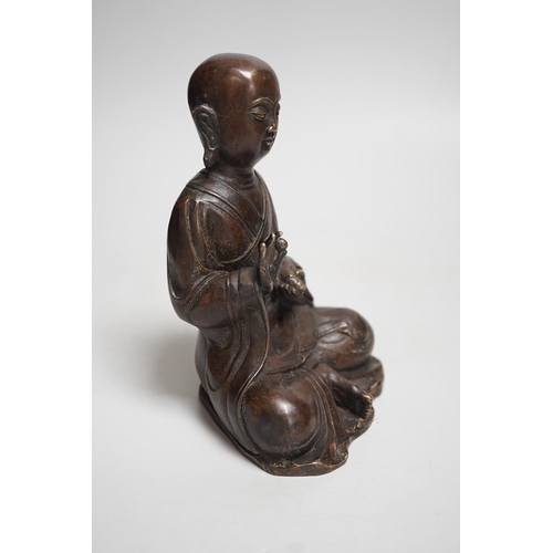 1390 - A Nepalese bronze figure of a seated immortal, probably 17th / 18th century, 16cm