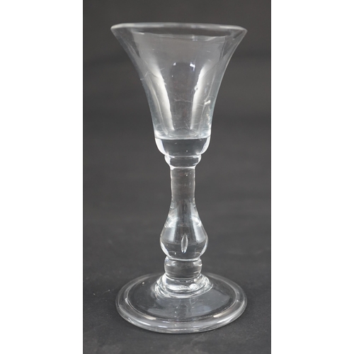 105 - A true baluster wine or cordial glass, c.1720, the bell-shaped bowl above a tear drop baluster stem,... 