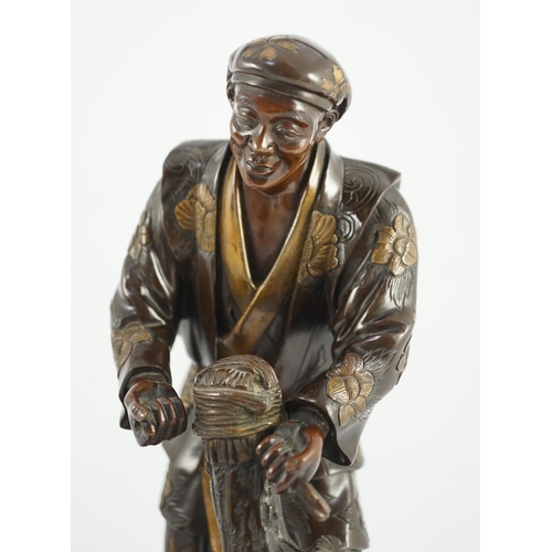 112 - A Japanese brown patinated and gilded bronze figure of a woodworker, in Miyao style, Meiji period, h... 