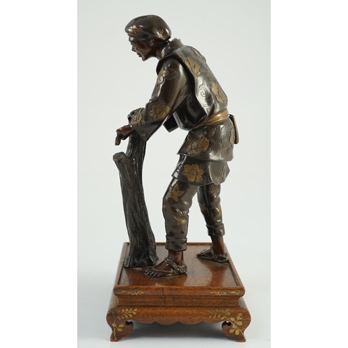 112 - A Japanese brown patinated and gilded bronze figure of a woodworker, in Miyao style, Meiji period, h... 