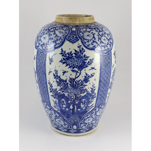 120 - A large Chinese blue and white large ovoid jar, Kangxi period, painted to four reserves with birds a... 