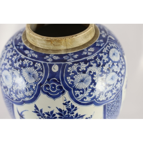 120 - A large Chinese blue and white large ovoid jar, Kangxi period, painted to four reserves with birds a... 