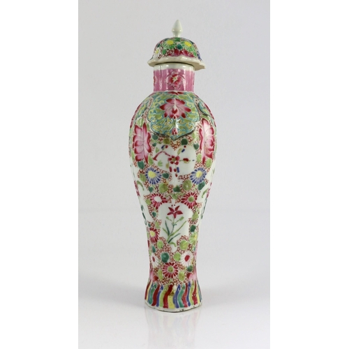 128 - A Chinese famille rose moulded baluster vase, Qianlong period, painted with trailing flowers on a ce... 