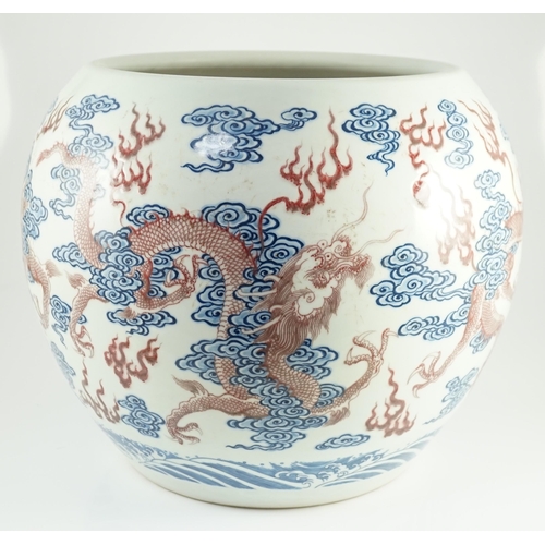 142 - A large Chinese underglaze blue and copper red 'dragon' scroll vessel, of globular form, painted in ... 