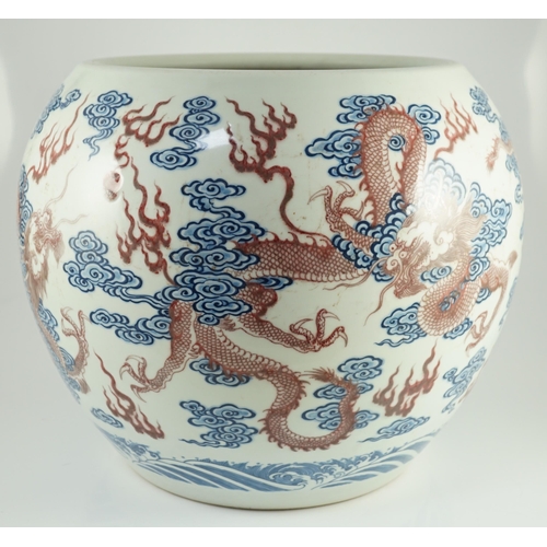 142 - A large Chinese underglaze blue and copper red 'dragon' scroll vessel, of globular form, painted in ... 