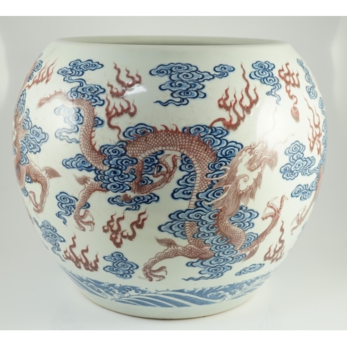 142 - A large Chinese underglaze blue and copper red 'dragon' scroll vessel, of globular form, painted in ... 